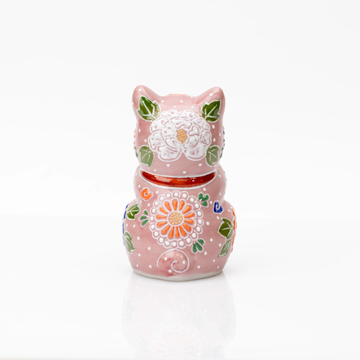 Back of the pink floral praying cat with a red collar.