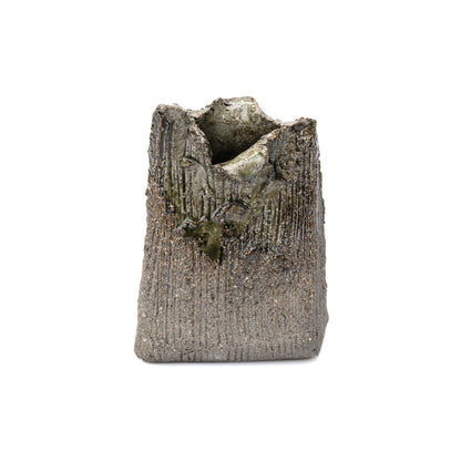Front view of a gray Shigaraki rectangular bud vase with an uneven opening and green glaze.