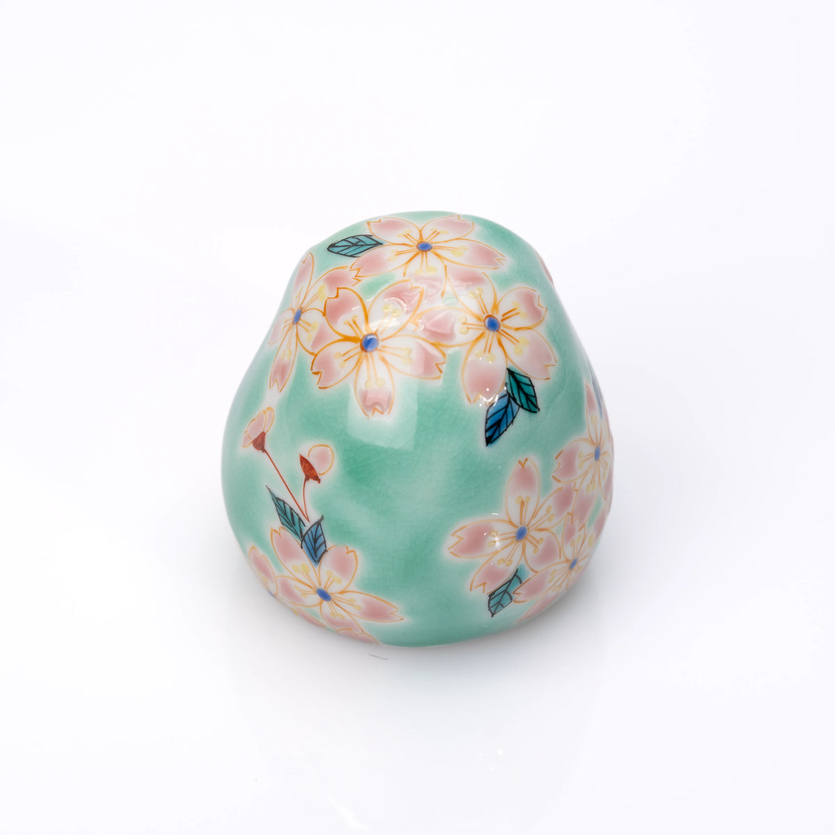 Opposite side of the turquoise daruma with cherry blossoms.