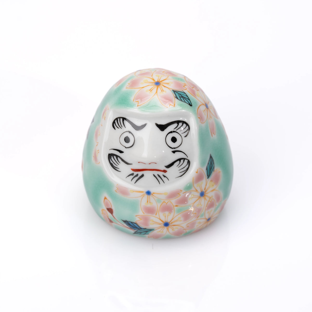 Front angle of the turquoise cherry blossom daruma.