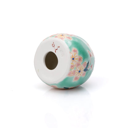 Underside of the cherry blossom daruma with a round opening.