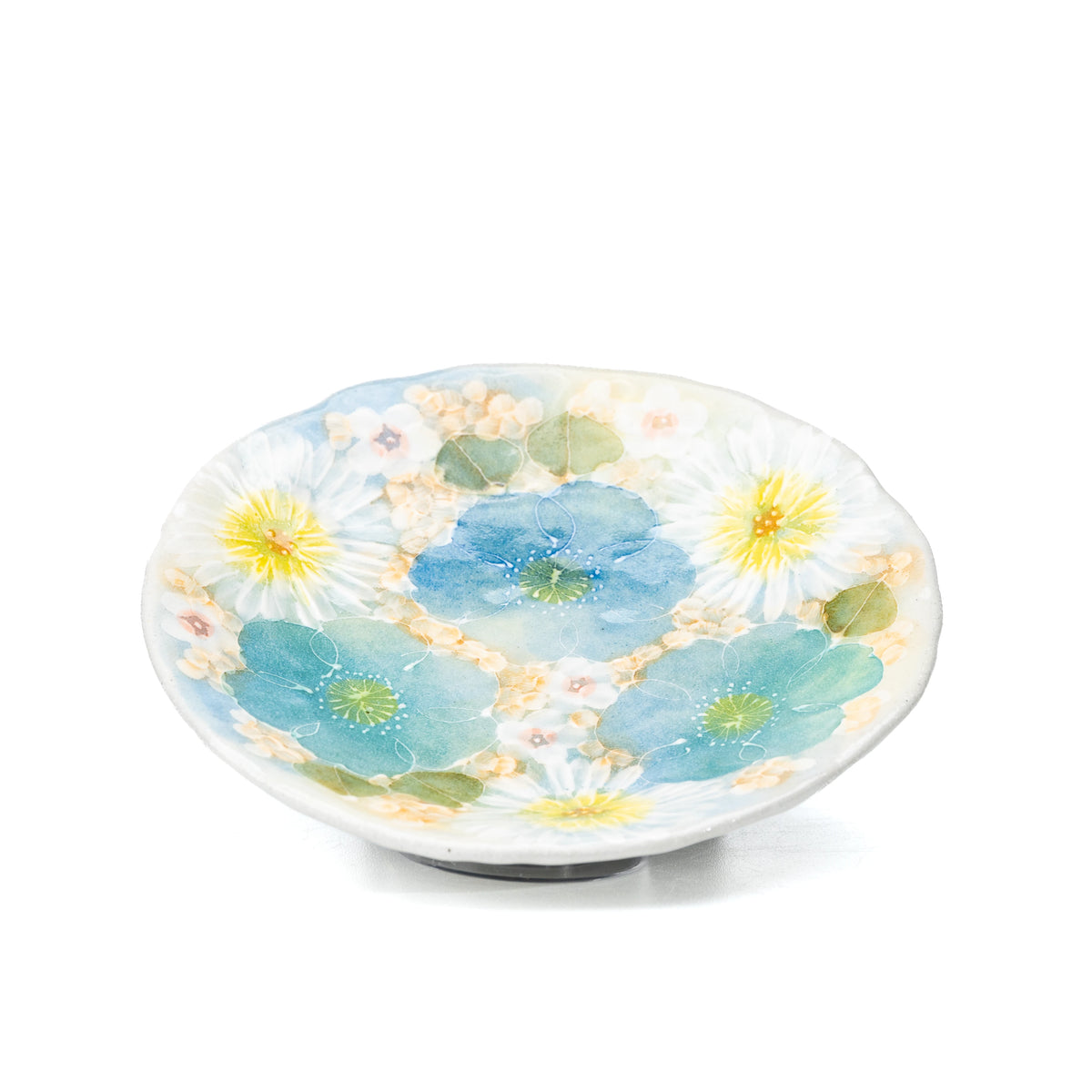 Floral saucer with blue and yellow flowers viewed from above.