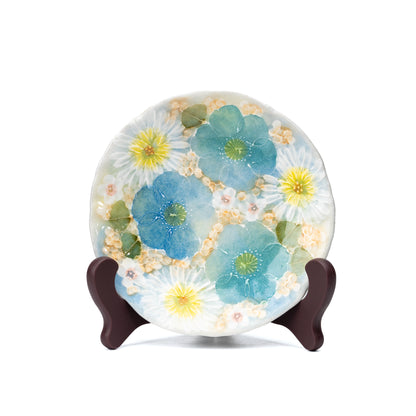 Floral saucer displayed upright on a small stand.