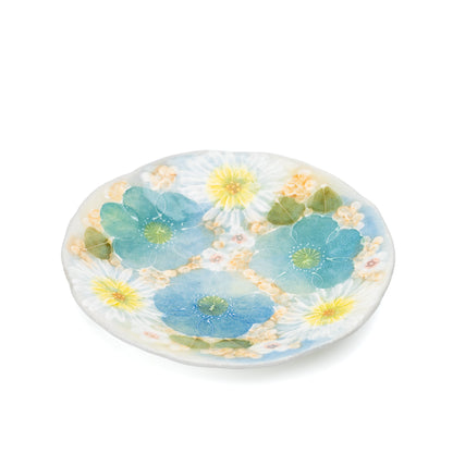 Angled view of the blue and yellow floral saucer.