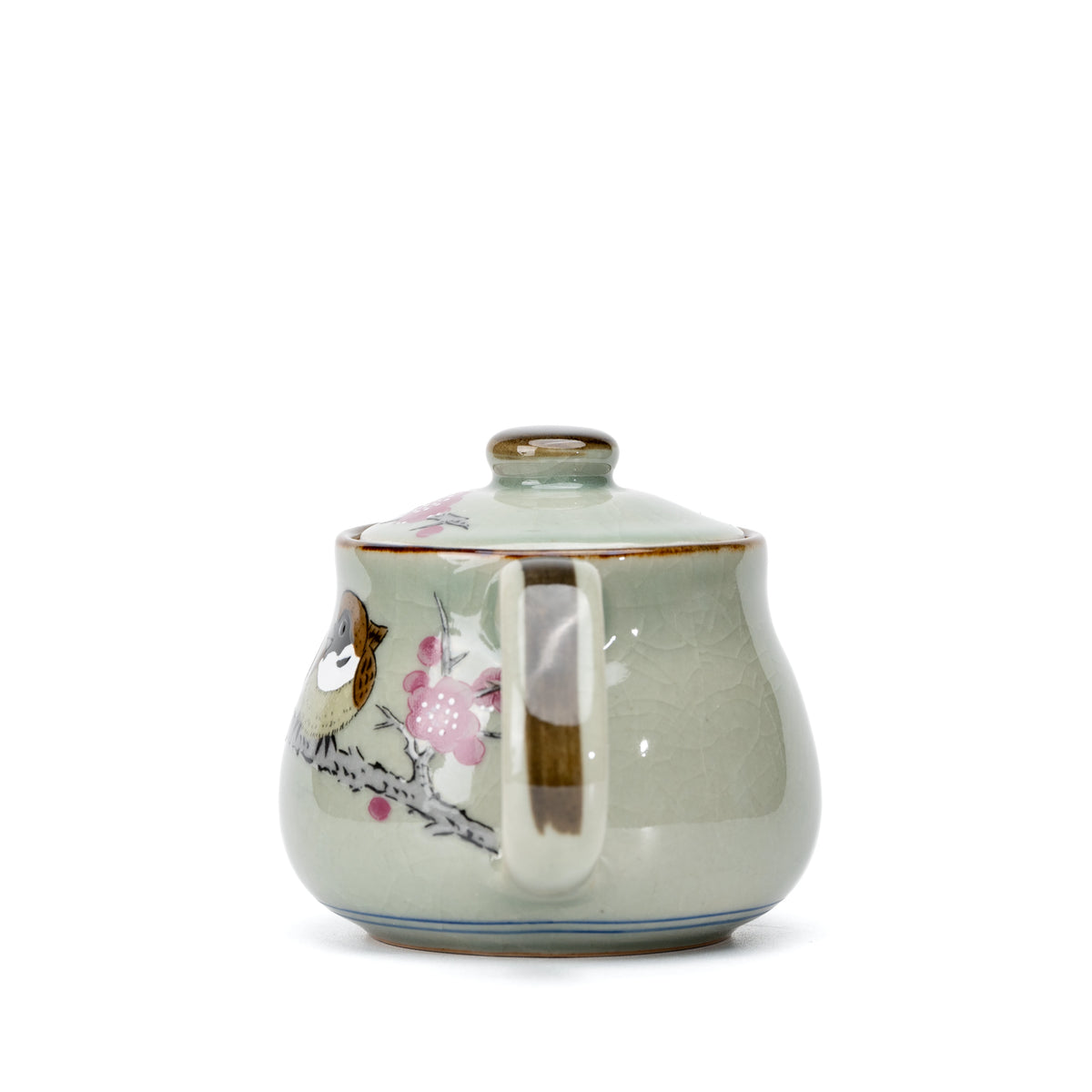 Side view of the sparrow teapot with pink blossoms beside the handle.