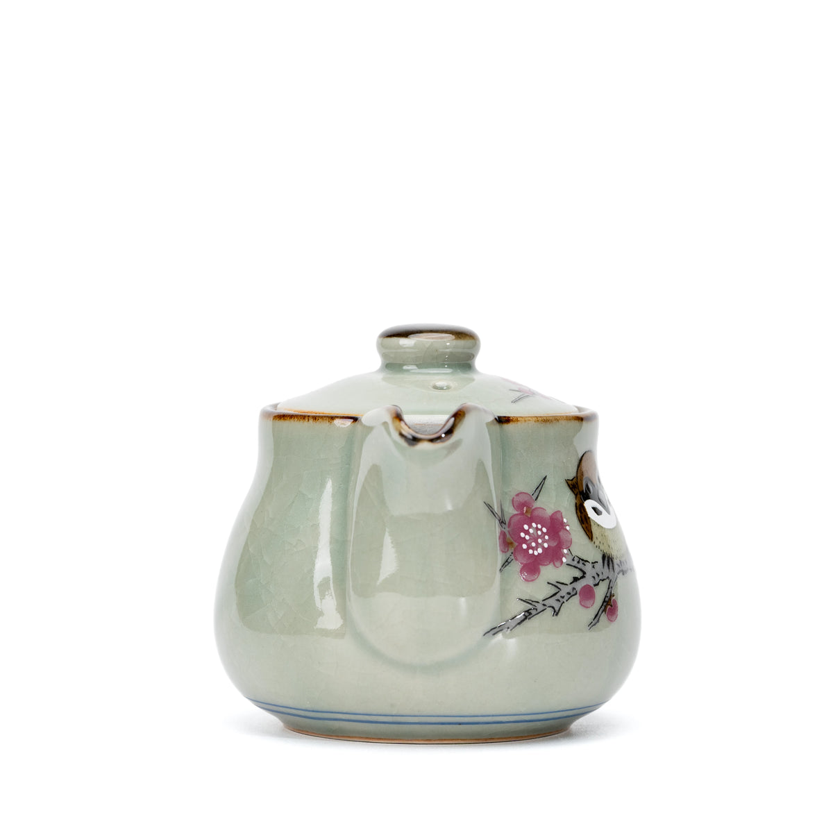Front view of the spout and pink floral decoration on the teapot.