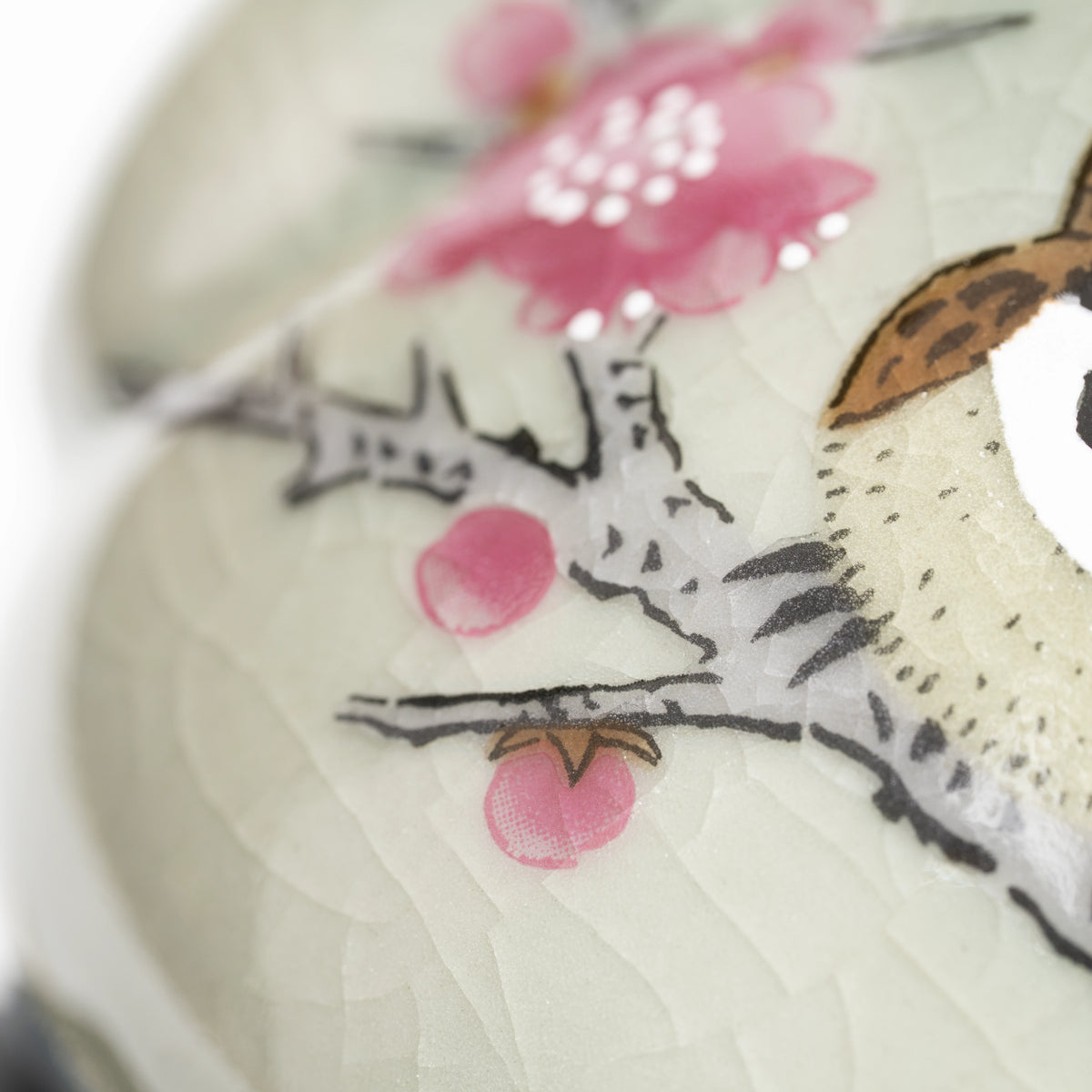 Pink blossoms and fine lines in the pale gray-green glaze.