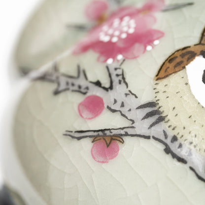 Pink blossoms and fine lines in the pale gray-green glaze.