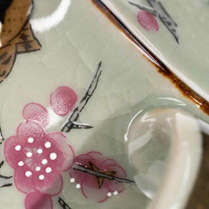 Close-up of pink flowers, fine stems and brown lid rim.