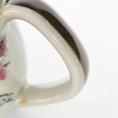 Curved teapot handle with brown edging.