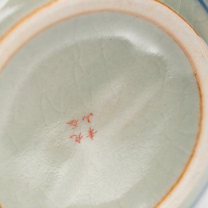 Red maker's mark on the glazed underside of the teapot.