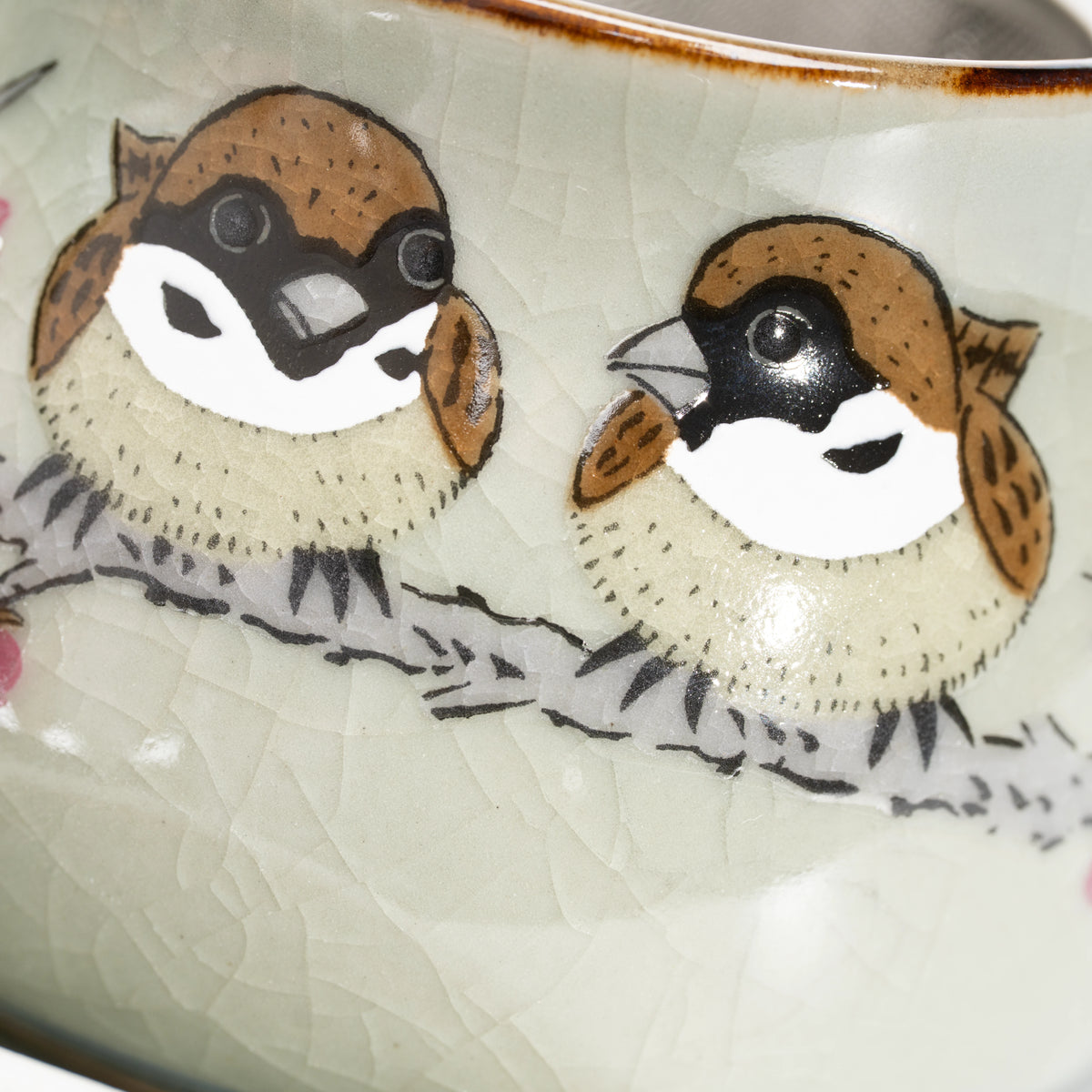 Close-up of the two round painted sparrows.