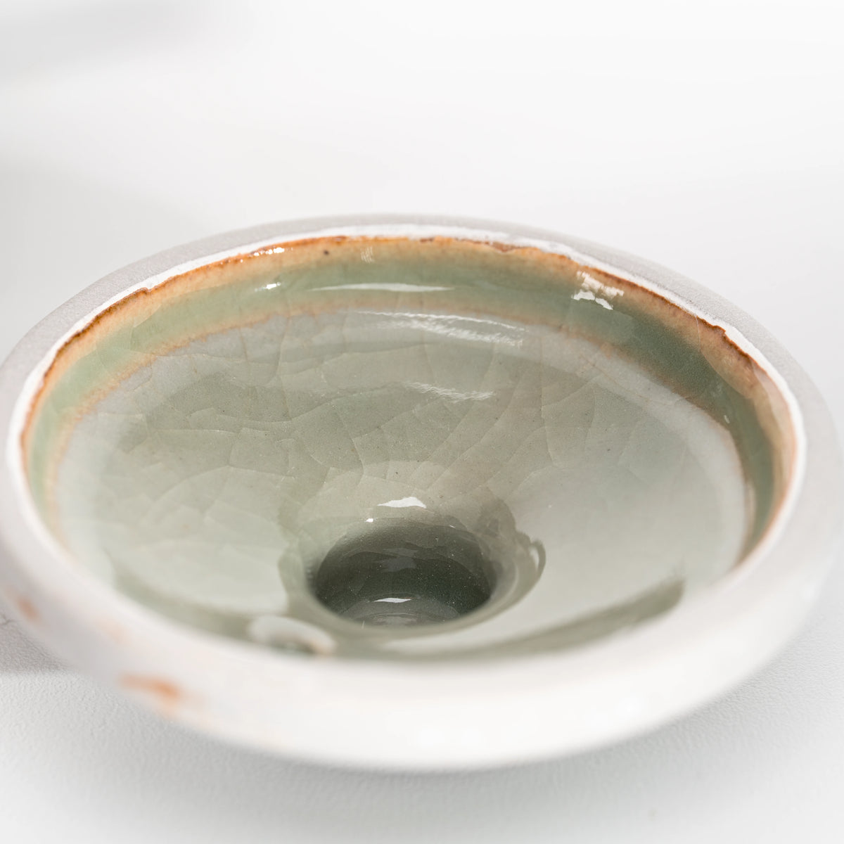 Glazed underside of the teapot lid, showing the circular inner rim.