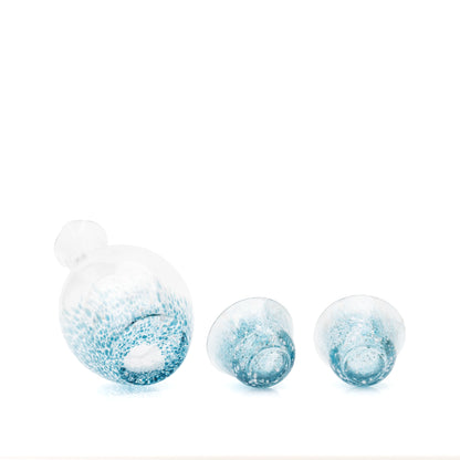 Undersides of the blue glass carafe and two cups.