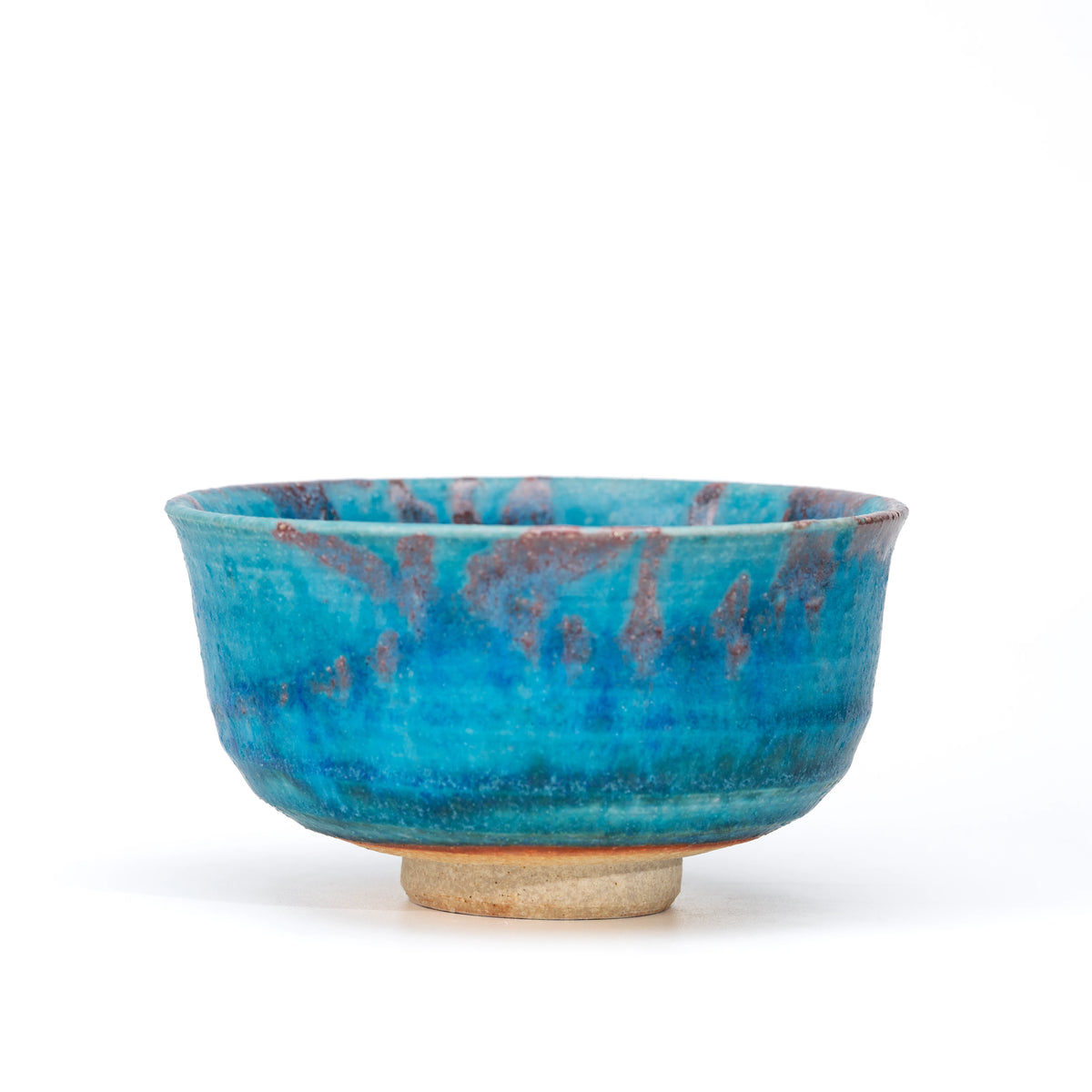 Opposite side of the blue glazed bowl with purple-brown bands.