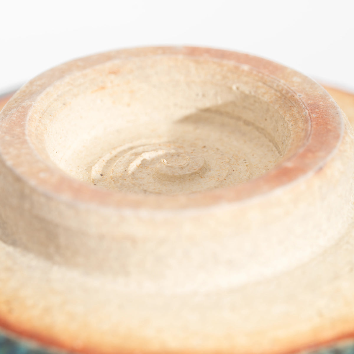 Unglazed underside and recessed circular foot of the matcha bowl.