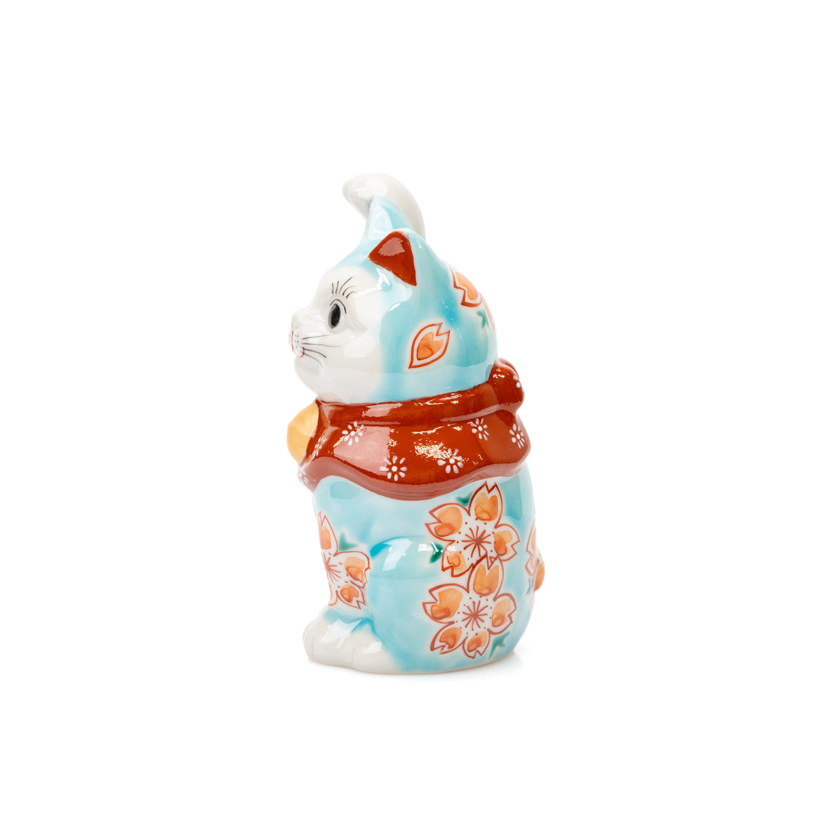 Side view of the turquoise lucky cat and its red floral bib.