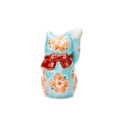 Back of the turquoise lucky cat with a red bow and cherry blossoms.