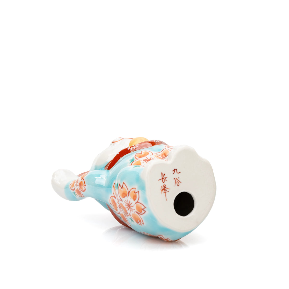 Underside of the turquoise lucky cat and its hollow opening.