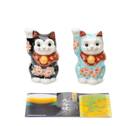 Black and turquoise cherry blossom cats shown together with printed leaflets for comparison.