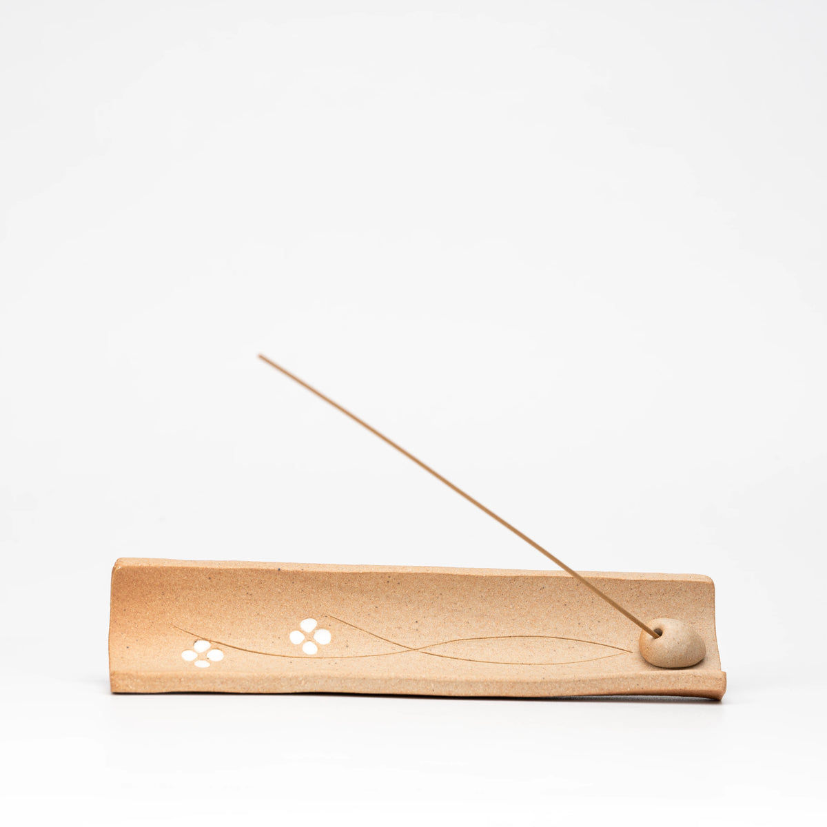 Opposite view of the brown floral incense tray and stick insert.