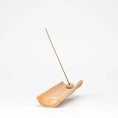 End view showing the raised sides of the brown incense holder.