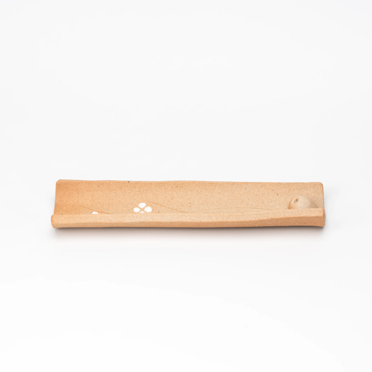Brown floral incense tray shown from above.