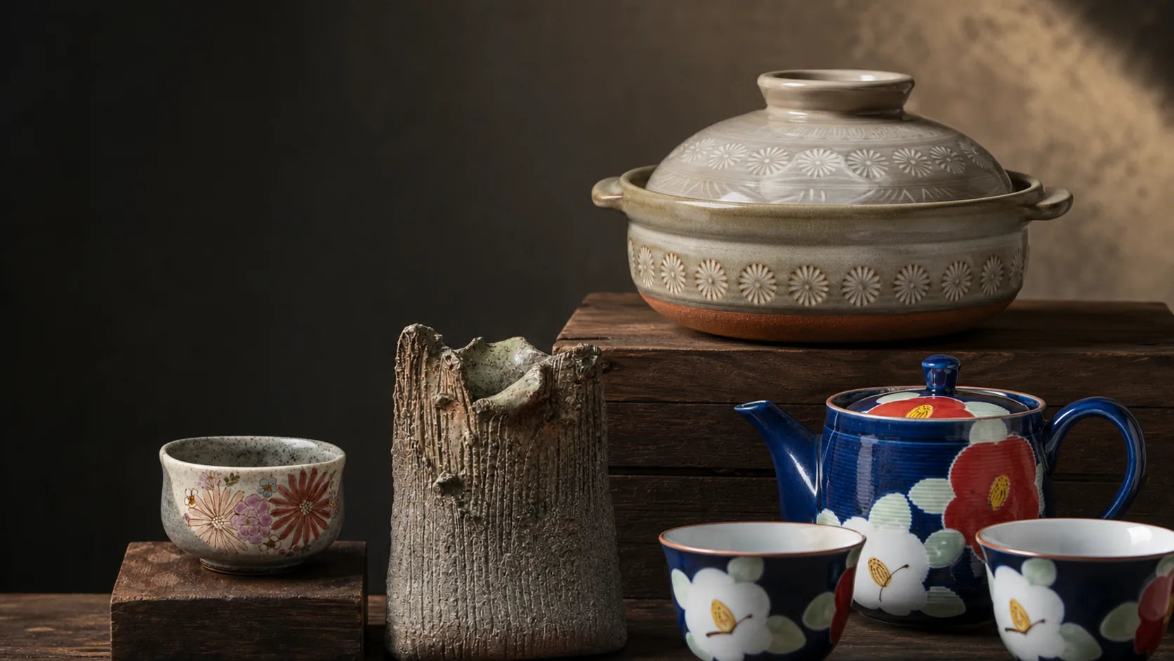 Japanese ceramic vessels in contrasting clay bodies and glazes arranged as a material study.